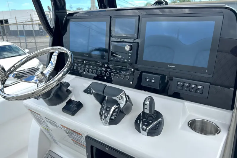 Slide: The Image of Control panel of 2026 Sea Fox 282 Hybrid LT boat with steering wheel and displays. - 7