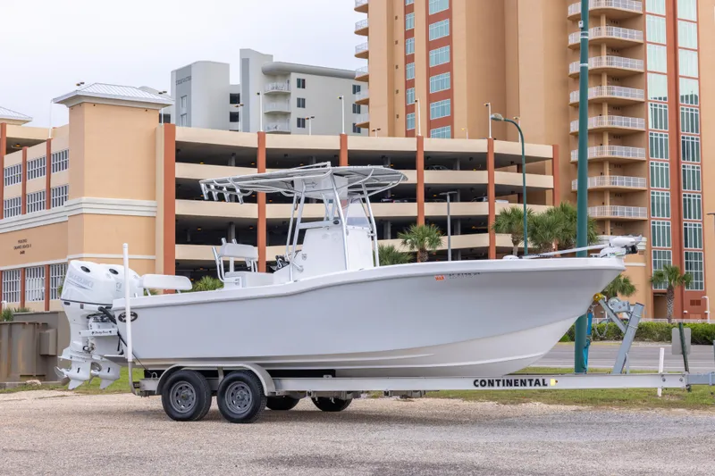 The Image of 2023 Dusky 252 Open Fisherman boat on trailer, urban background. - 1