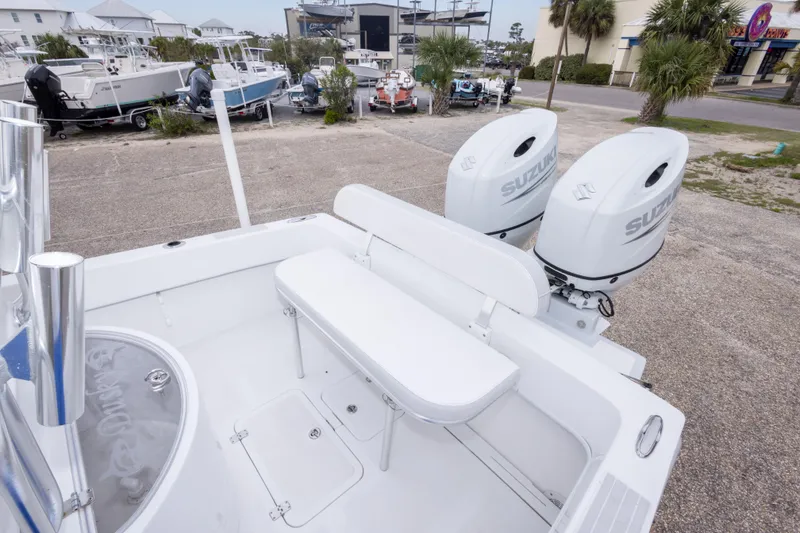 Slide: The Image of 2023 Dusky 252 Open Fisherman boat with dual Suzuki outboard engines, docked in a marina. - 17