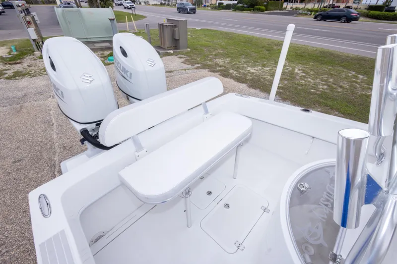 Slide: The Image of 2023 Dusky 252 Open Fisherman boat with dual Suzuki engines, docked near a road. - 18