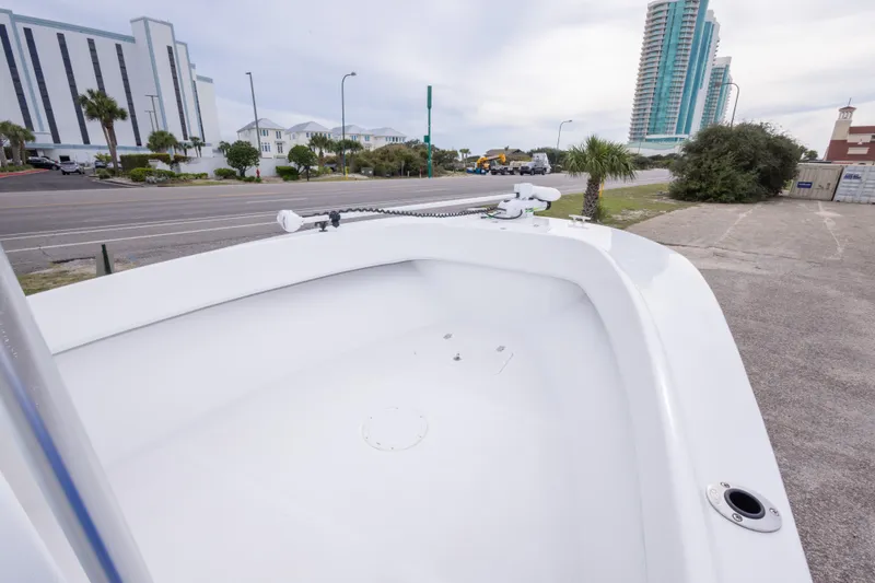 Slide: The Image of 2023 Dusky 252 Open Fisherman boat on urban street with modern buildings. - 21