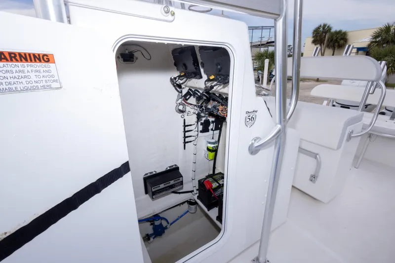 Slide: The Image of 2023 Dusky 252 Open Fisherman boat interior wiring and storage compartment. - 23