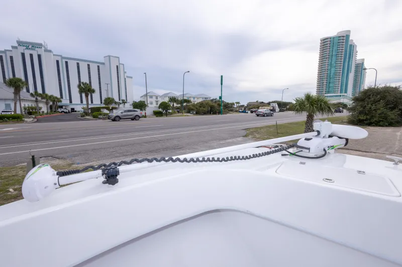 Slide: The Image of 2023 Dusky 252 Open Fisherman boat with trolling motor, cityscape background. - 24