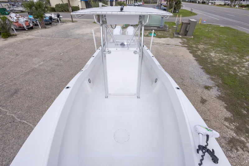 Slide: The Image of 2023 Dusky 252 Open Fisherman boat, spacious deck view, parked outdoors. - 26