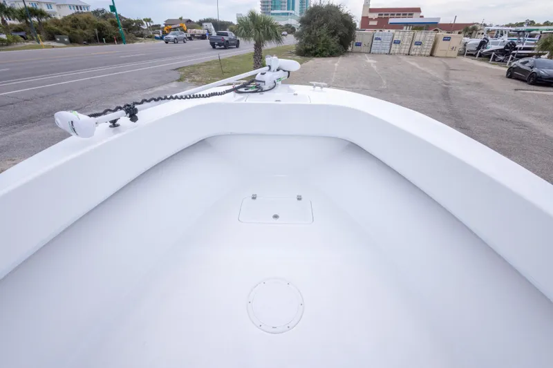 Slide: The Image of 2023 Dusky 252 Open Fisherman boat bow with trolling motor, parked near a road. - 27