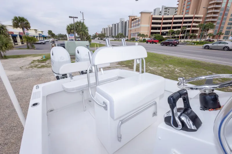 Slide: The Image of 2023 Dusky 252 Open Fisherman boat with dual engines, parked near a road. - 29