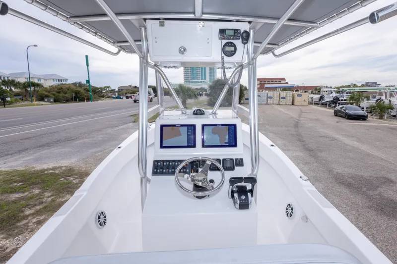 Slide: The Image of 2023 Dusky 252 Open Fisherman boat dashboard with navigation screens and controls. - 30