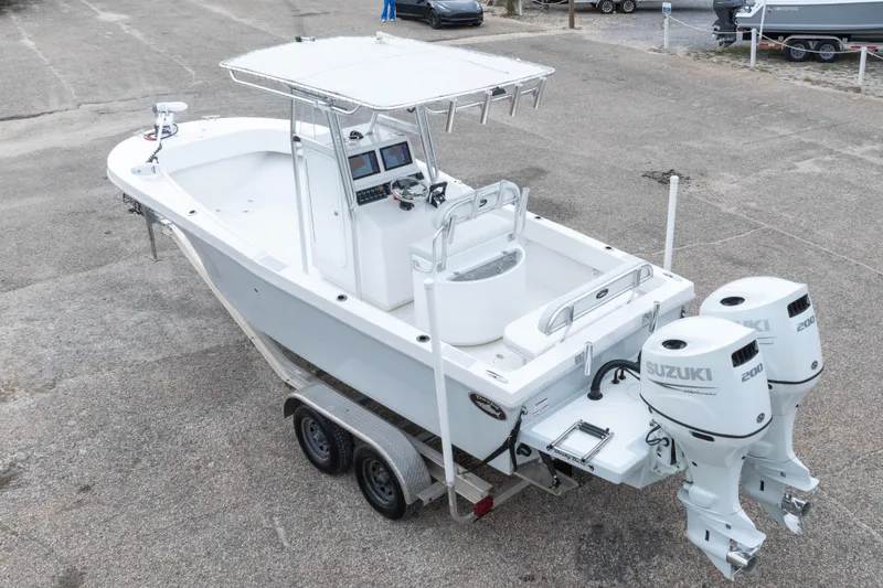 Slide: The Image of 2023 Dusky 252 Open Fisherman boat with dual Suzuki 200 engines on a trailer. - 36