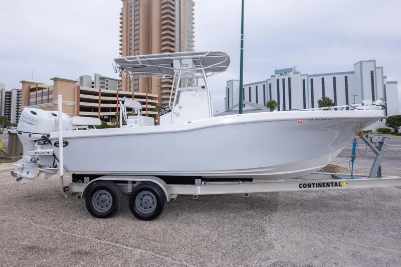 Slide: The Image of 2023 Dusky 252 Open Fisherman boat on trailer, urban background. - 4