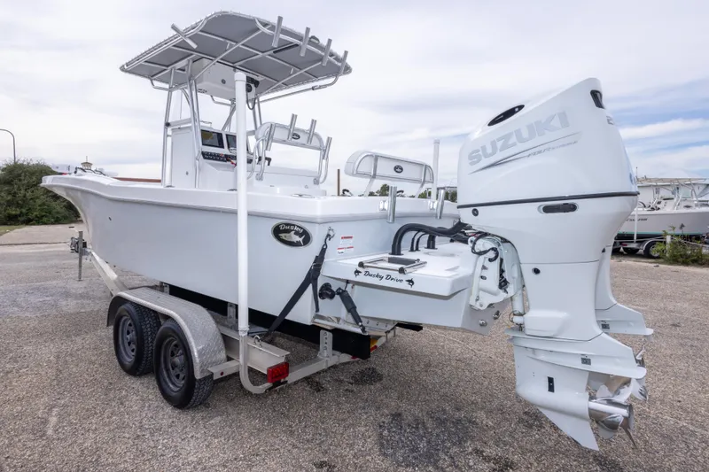 Slide: The Image of 2023 Dusky 252 Open Fisherman boat with Suzuki outboard engine on trailer. - 7