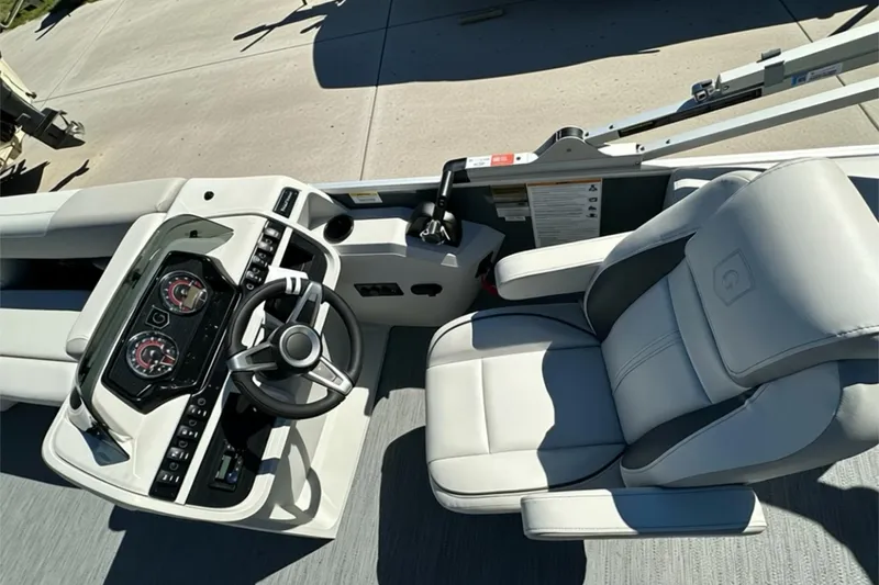 Slide: The Image of Captain's seat and helm of 2026 Sweetwater SW2086CPSE boat, featuring modern controls and gauges. - 12