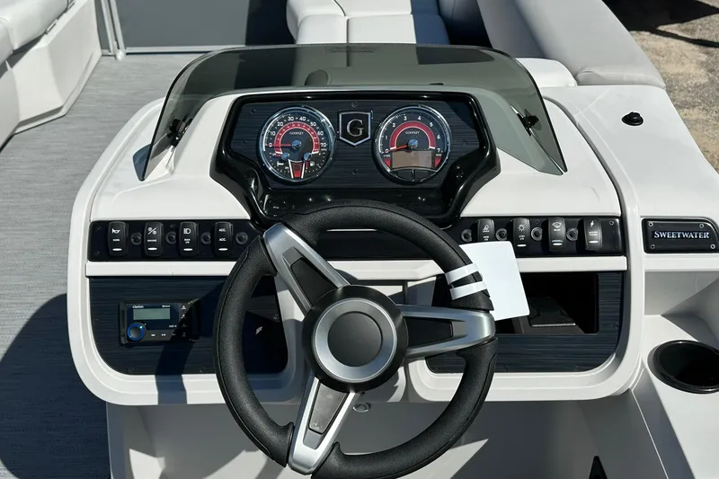 Slide: The Image of Dashboard of a 2026 Sweetwater SW2086CPSE boat with steering wheel and gauges. - 13