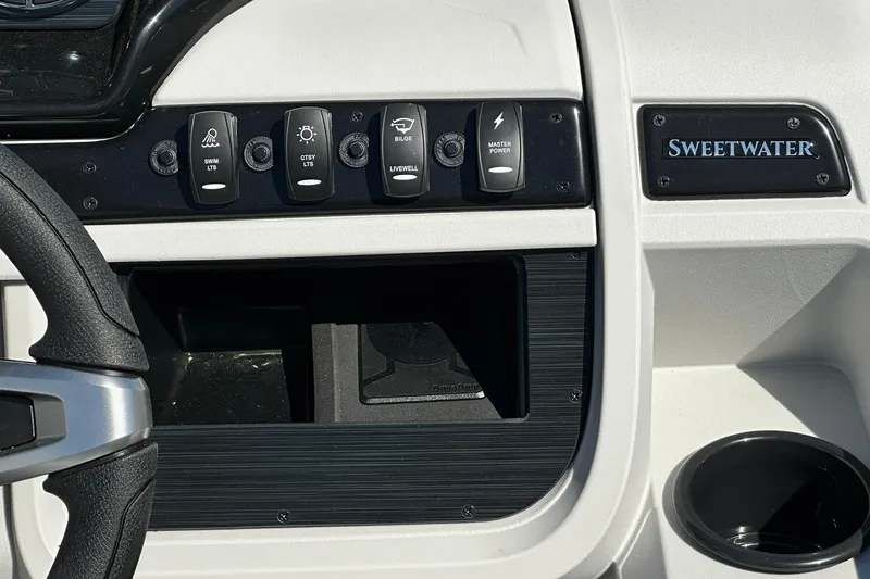 Slide: The Image of Dashboard of 2026 Sweetwater SW2086CPSE boat with control switches and logo. - 16