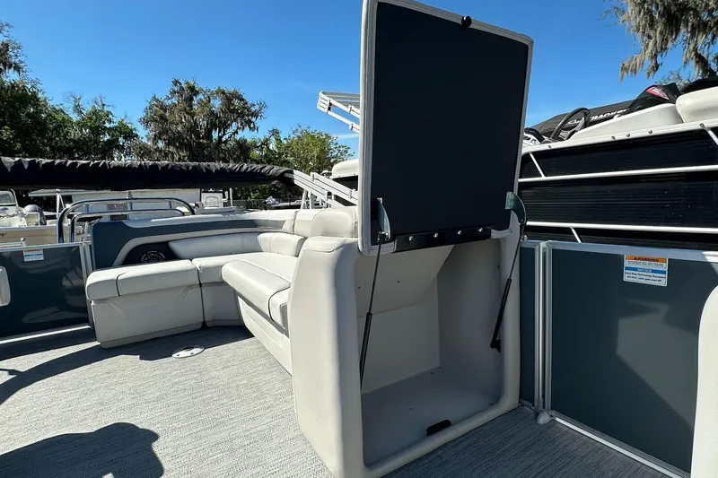 Slide: The Image of 2026 Sweetwater SW2086CPSE pontoon boat interior with open storage compartment and seating. - 24