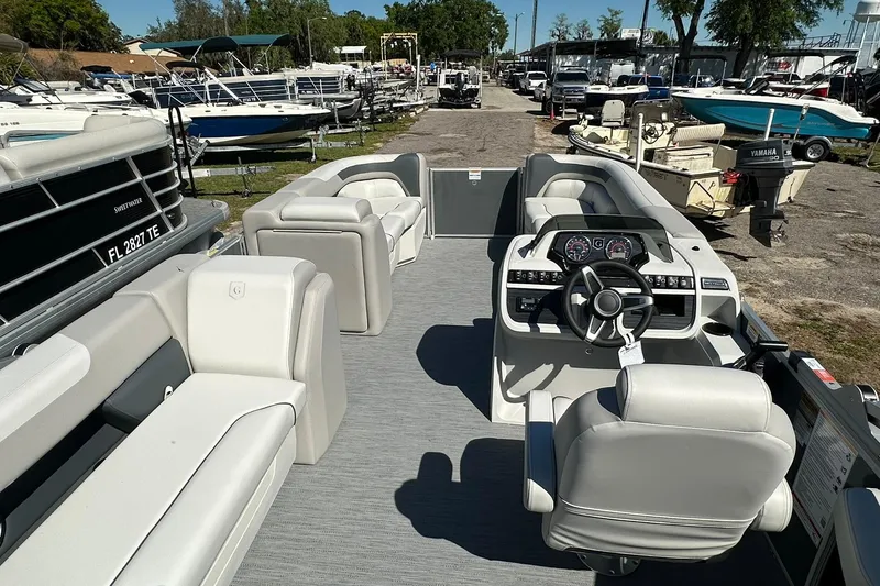 Slide: The Image of 2026 Sweetwater SW2086CPSE pontoon boat with spacious seating and modern dashboard. - 26