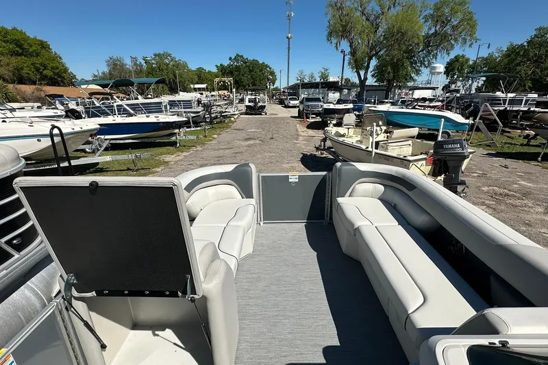 Slide: The Image of 2026 Sweetwater SW2086CPSE pontoon boat interior at a marina with other boats. - 29