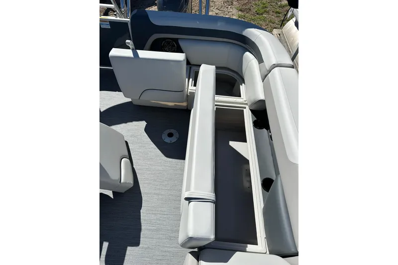 Slide: The Image of Sweetwater SW2086CPSE 2026 boat interior with open storage compartment and gray seating. - 32