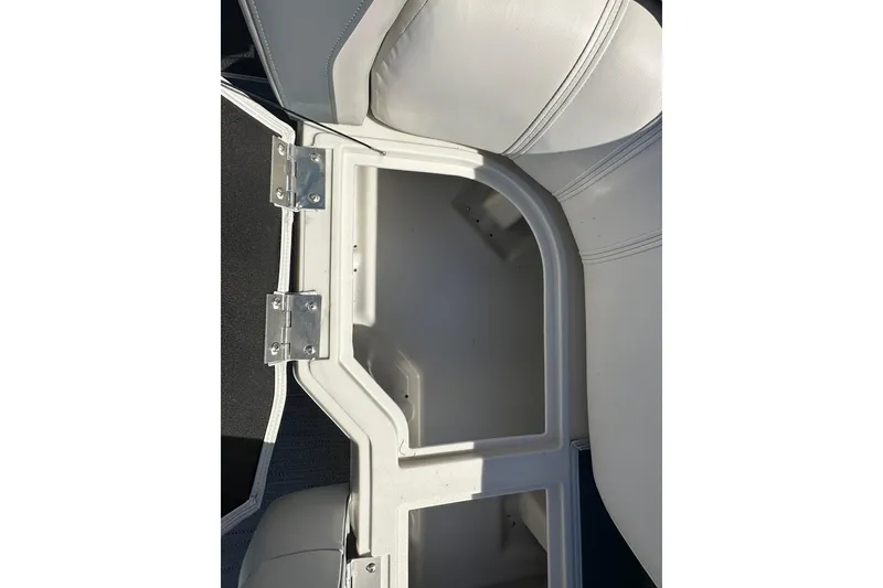 Slide: The Image of Open storage compartment in 2026 Sweetwater SW2086CPSE boat, featuring white cushioned seating. - 35