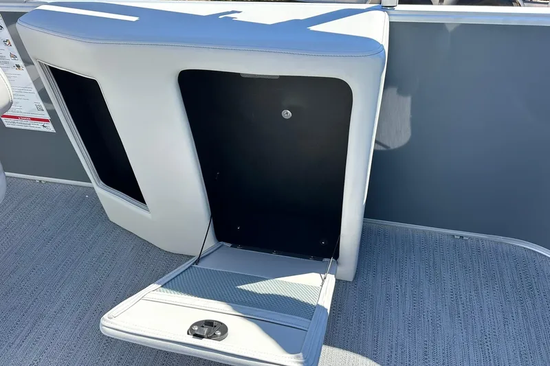 Slide: The Image of Open storage compartment on a 2026 Sweetwater SW2086CPSE boat. - 38