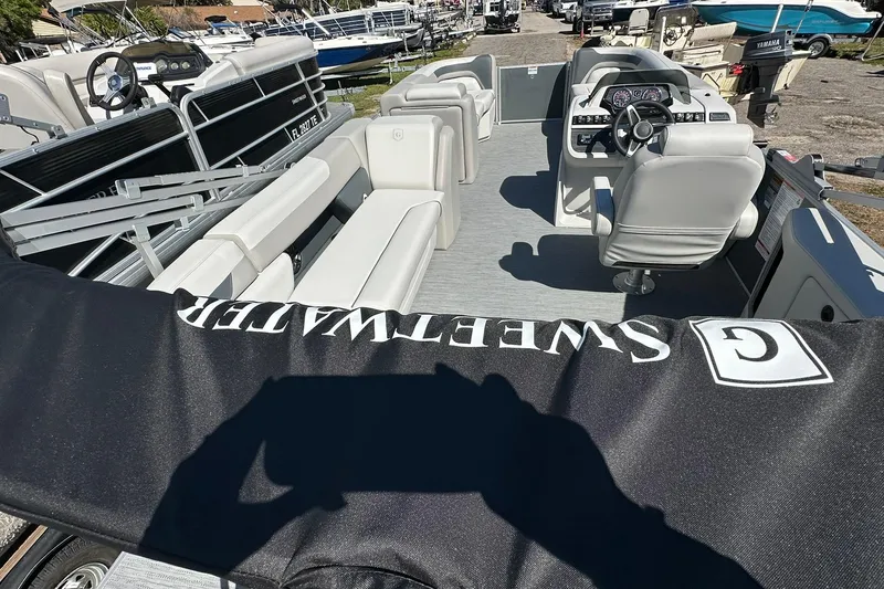 Slide: The Image of 2026 Sweetwater SW2086CPSE pontoon boat interior with seating and steering console. - 48