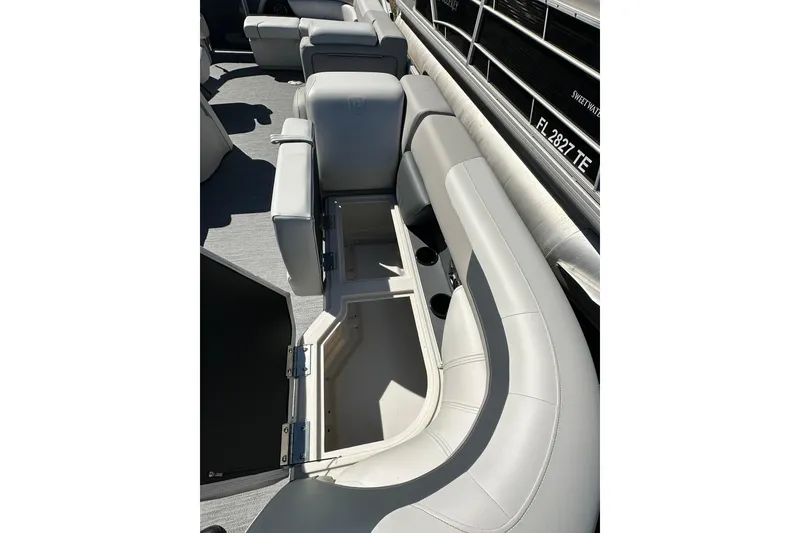 Slide: The Image of 2026 Sweetwater SW2086CPSE boat interior with open storage compartment and cushioned seating. - 8