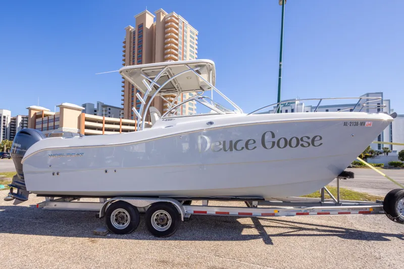 The Image of 2016 World Cat 255 DC boat on trailer, urban background, sunny day. - 0