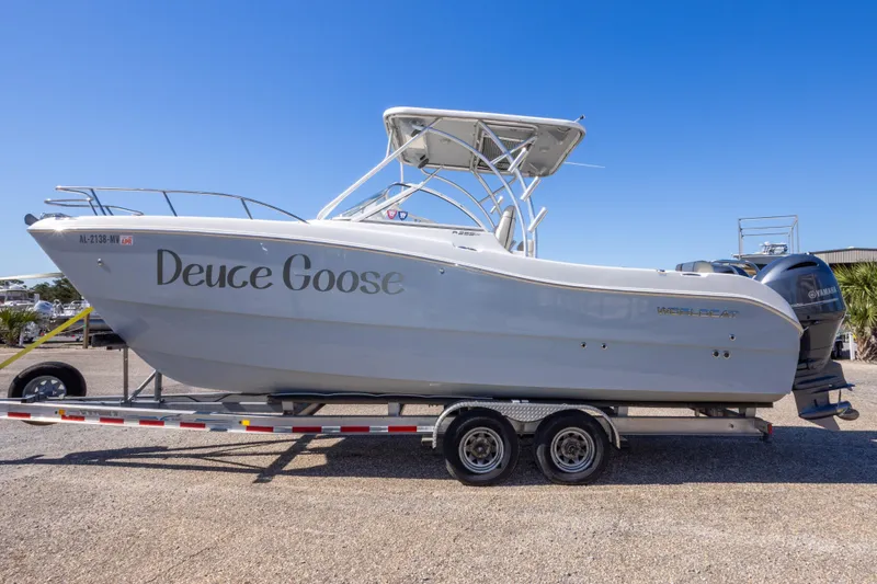 Slide: The Image of 2016 World Cat 255 DC boat named "Deuce Goose" on a trailer, side view. - 10