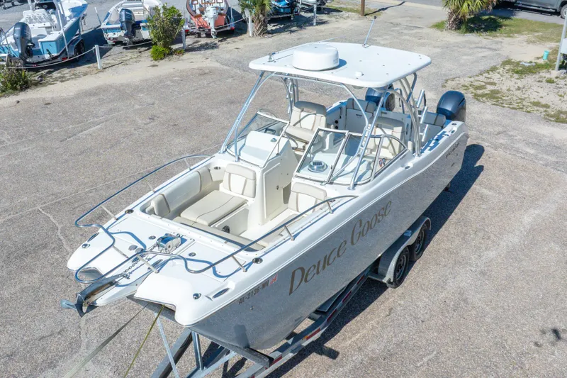 Slide: The Image of 2016 World Cat 255 DC boat on trailer, aerial view, parked outdoors. - 14