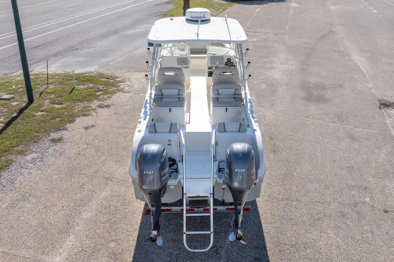 Slide: The Image of 2016 World Cat 255 DC boat with twin Yamaha 150 engines, parked on pavement. - 16