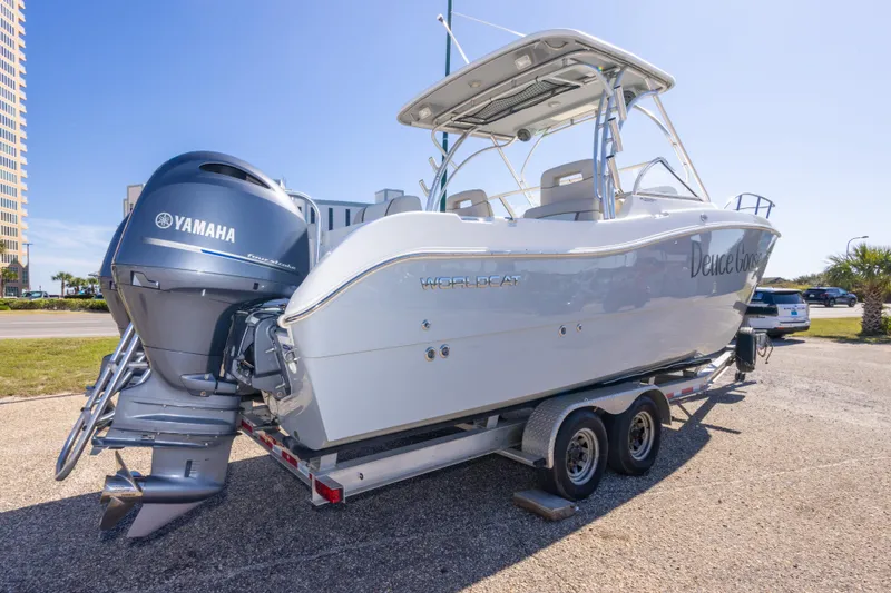 Slide: The Image of 2016 World Cat 255 DC boat on trailer with Yamaha engine, parked outdoors. - 17