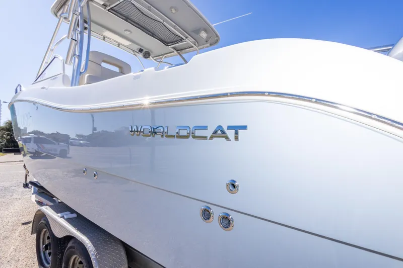 Slide: The Image of 2016 World Cat 255 DC boat on trailer, side view under clear blue sky. - 21