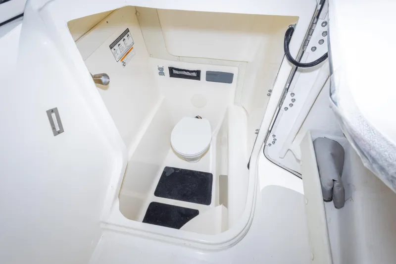 Slide: The Image of Interior view of a 2016 World Cat 255 DC boat's compact marine toilet area. - 29