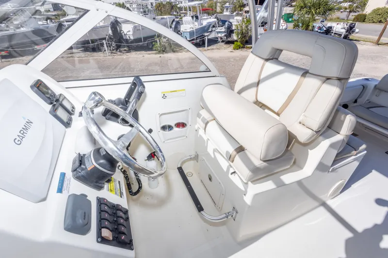 Slide: The Image of 2016 World Cat 255 DC boat cockpit with Garmin navigation and comfortable seating. - 30
