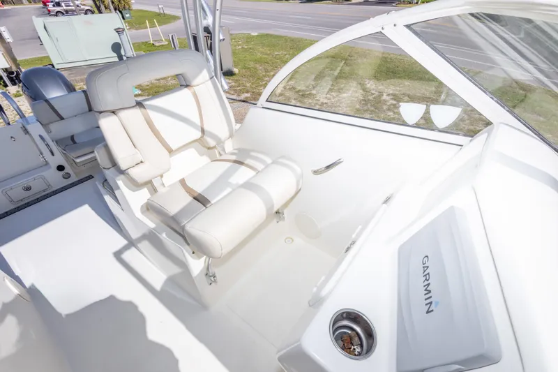 Slide: The Image of 2016 World Cat 255 DC boat interior with Garmin navigation system and comfortable seating. - 31