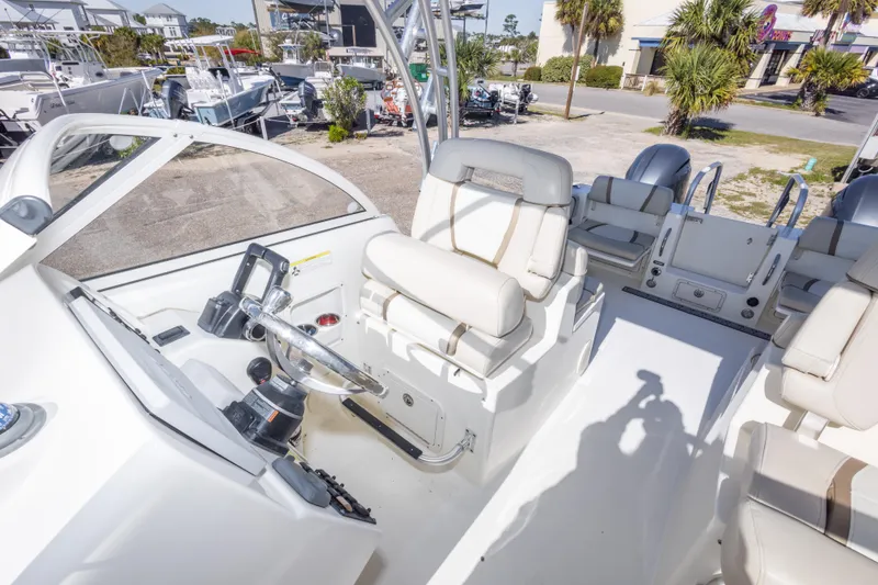 Slide: The Image of 2016 World Cat 255 DC boat interior with helm and seating area. - 32