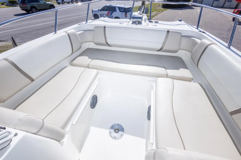 Slide: The Image of Spacious seating area on a 2016 World Cat 255 DC boat, featuring comfortable white upholstery. - 36