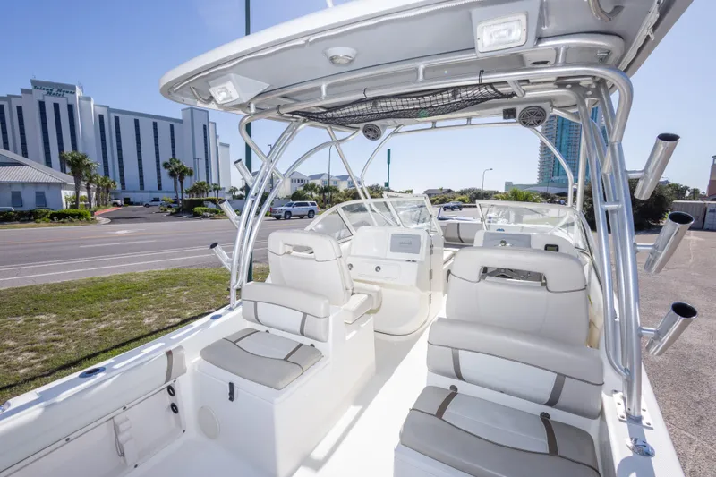 Slide: The Image of 2016 World Cat 255 DC boat interior with seating, parked near a hotel. - 40