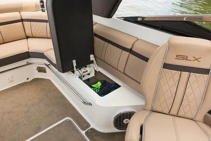 Slide: The Image of Manufacturer Provided Image: 2018 Sea Ray SLX 280 boat interior with tan leather seats and storage compartment. - 9