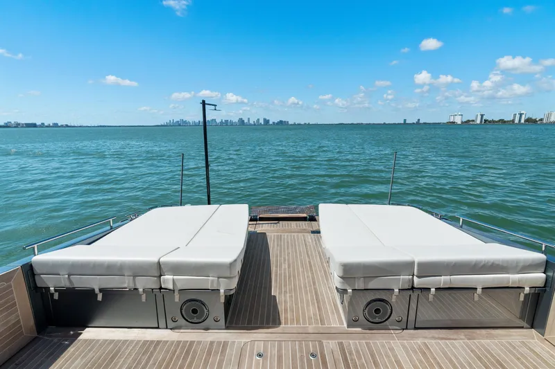 Slide: The Image of 2024 CNM CONTINENTAL 54 SuperSport yacht deck with sunbeds overlooking ocean. - 23