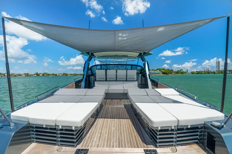 Slide: The Image of 2024 CNM CONTINENTAL 54 SuperSport yacht with sunbeds and canopy on open water. - 26