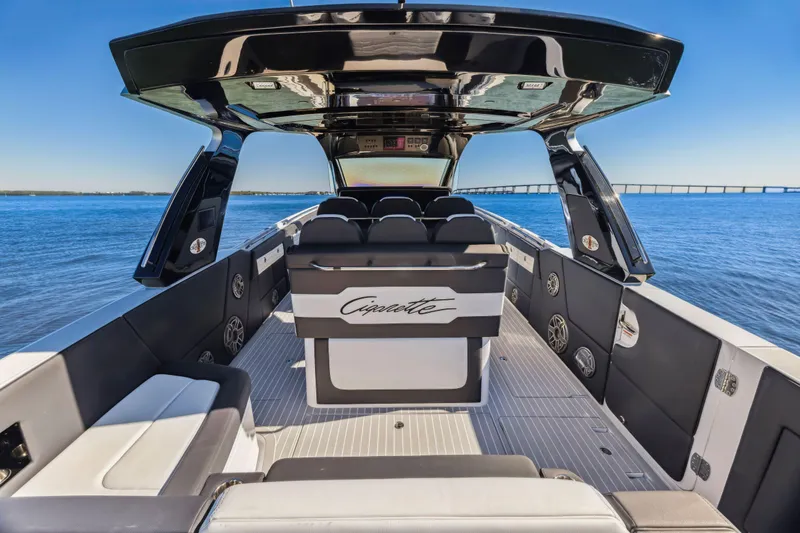 Slide: The Image of 2022 Cigarette 42 Auroris luxury boat interior with sleek seating and open water view. - 16