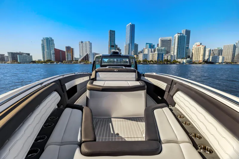 Slide: The Image of 2022 Cigarette 42 Auroris boat with luxury seating, city skyline in background. - 25