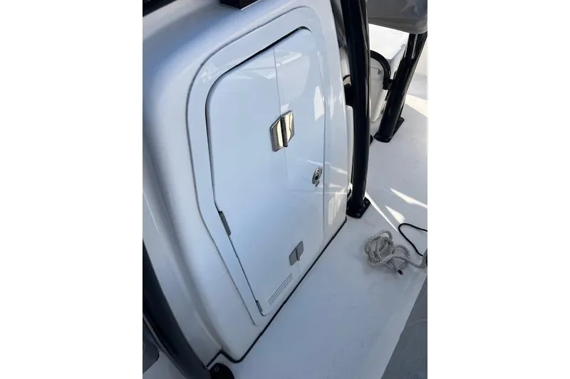 Slide: The Image of 2021 Sea Fox 228 Commander boat storage compartment with secure latch and rope on deck. - 14