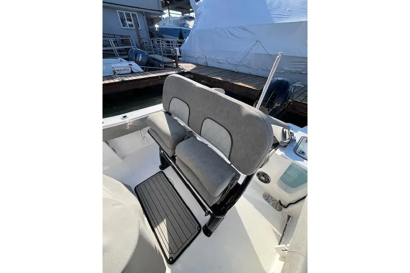 Slide: The Image of 2021 Sea Fox 228 Commander boat interior with cushioned seating and dock view. - 15