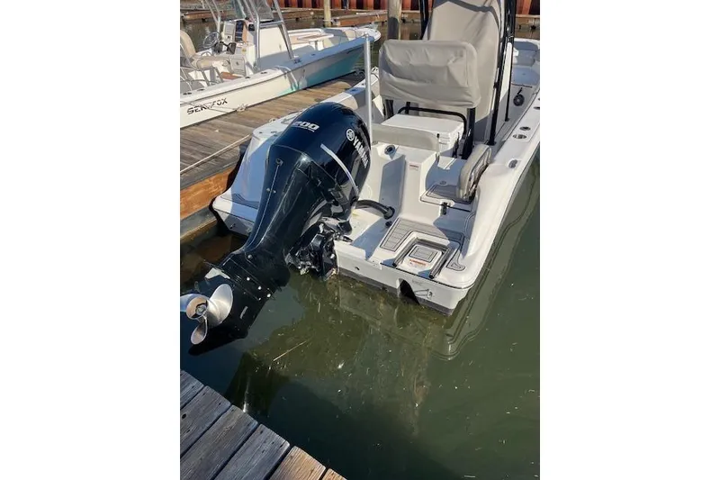 Slide: The Image of 2021 Sea Fox 228 Commander boat with Yamaha outboard motor docked in marina. - 2