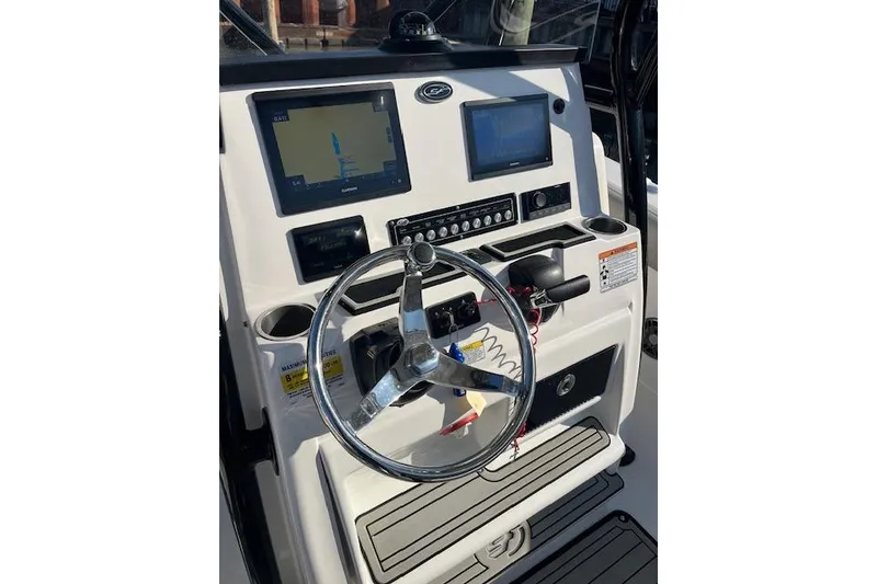Slide: The Image of 2021 Sea Fox 228 Commander boat dashboard with steering wheel and navigation screens. - 23