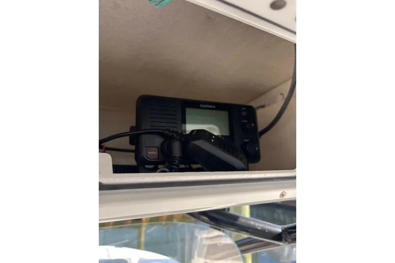 Slide: The Image of Garmin marine radio inside 2021 Sea Fox 228 Commander boat compartment. - 24