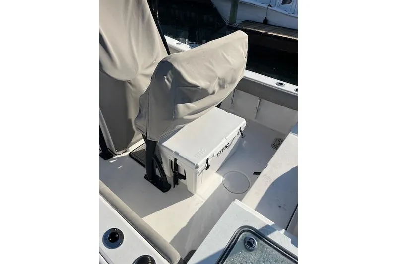 Slide: The Image of 2021 Sea Fox 228 Commander boat interior with covered seating and RTIC cooler. - 4