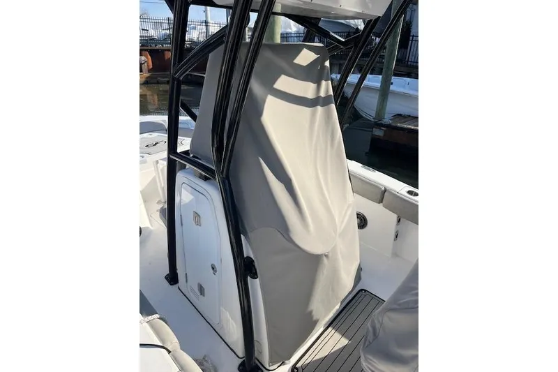 Slide: The Image of 2021 Sea Fox 228 Commander boat console with protective cover in marina setting. - 6