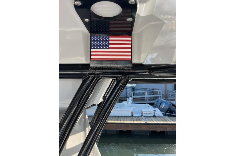 Slide: The Image of American flag on 2021 Sea Fox 228 Commander boat, docked with visible water and pier. - 8